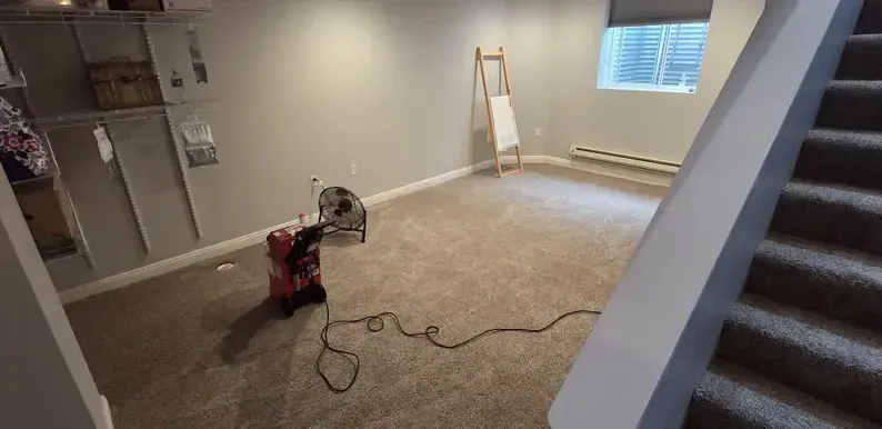 Air mover drying a room after the wet carpet came out
